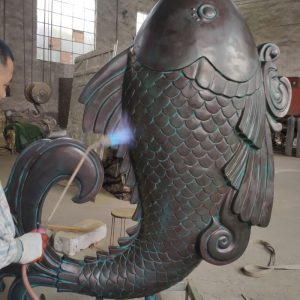 Bronze carp sculpture symbolizes pursuit of higher goals