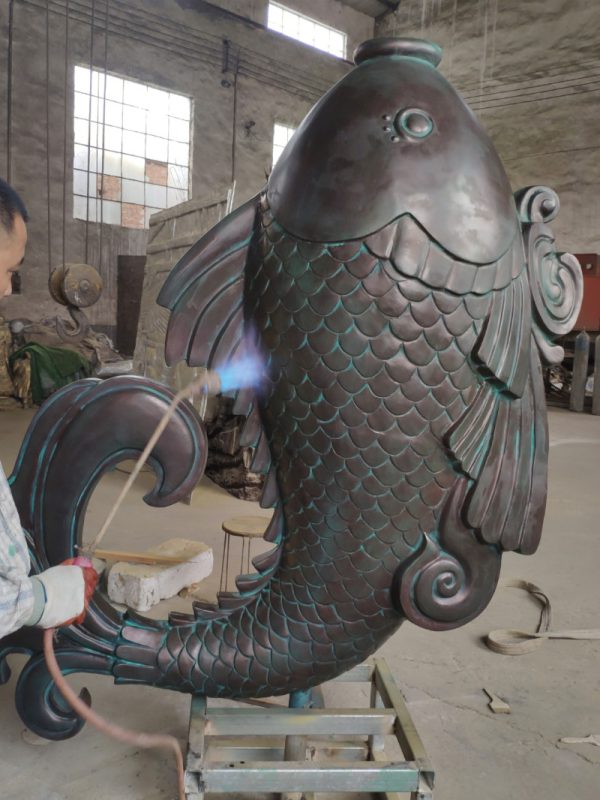 Bronze carp sculpture symbolizes pursuit of higher goals