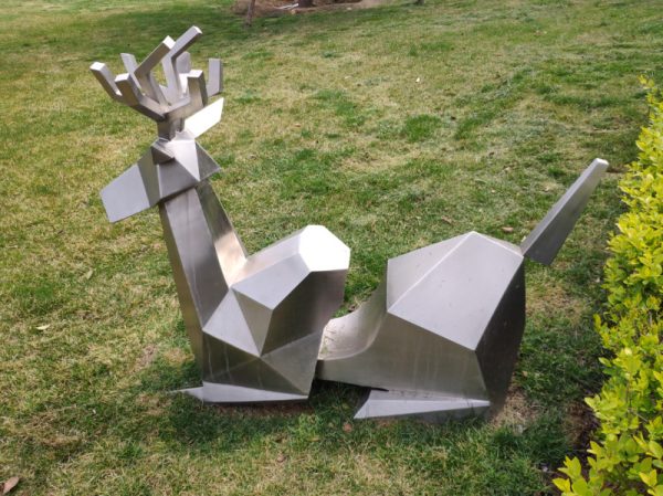 Stainless steel sheep sculpture lying on the green land of the park - Image 2