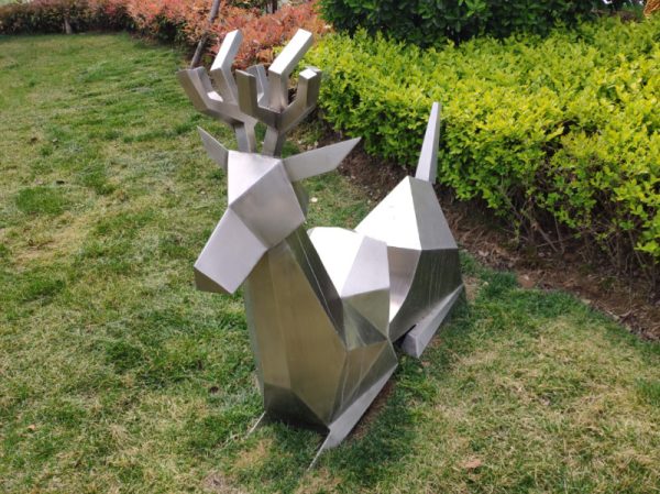 Stainless steel sheep sculpture lying on the green land of the park - Image 3