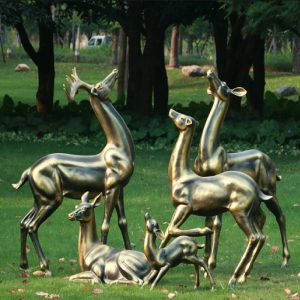 Bronze deer statue on the lawn beside the park