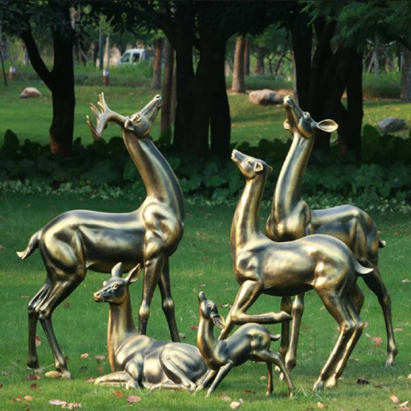 Bronze deer statue on the lawn beside the park