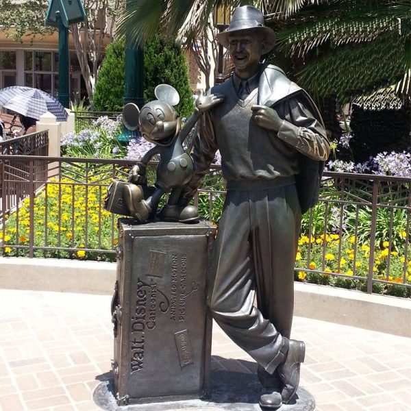 Bronze statue of a middle-aged man wearing a hat on the street in an outdoor park - Image 5