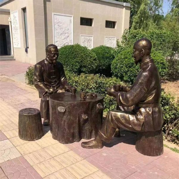 Bronze statue of two male old men sitting on a pole with teapots and cups, drinking tea in a park street - Image 2