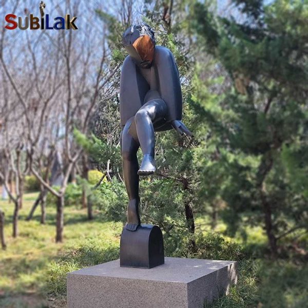 A bronze sculpture of a walking person