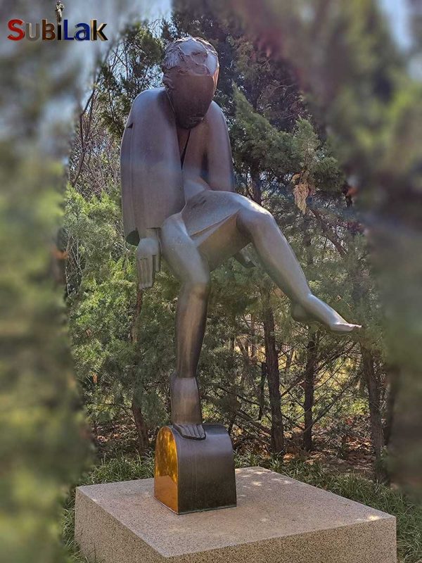 A bronze sculpture of a walking person