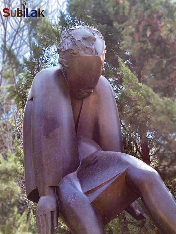 A bronze sculpture of a walking person