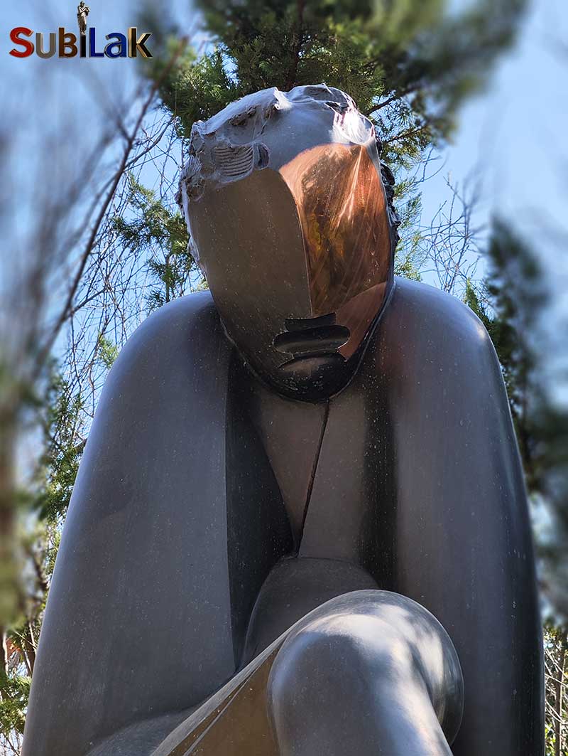 A bronze sculpture of a walking person