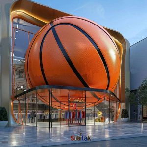 Giant fiberglass basketball sculpture in outdoor park square