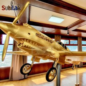 Gold fiberglass P-40 fighter model sculpture