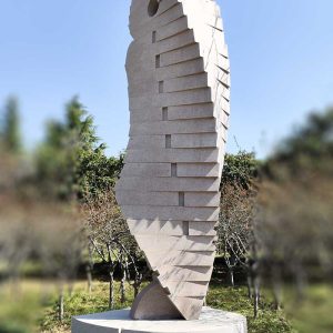 Stone Sculpture: An Abstract Standing Figure Observing and Alert in Twisting