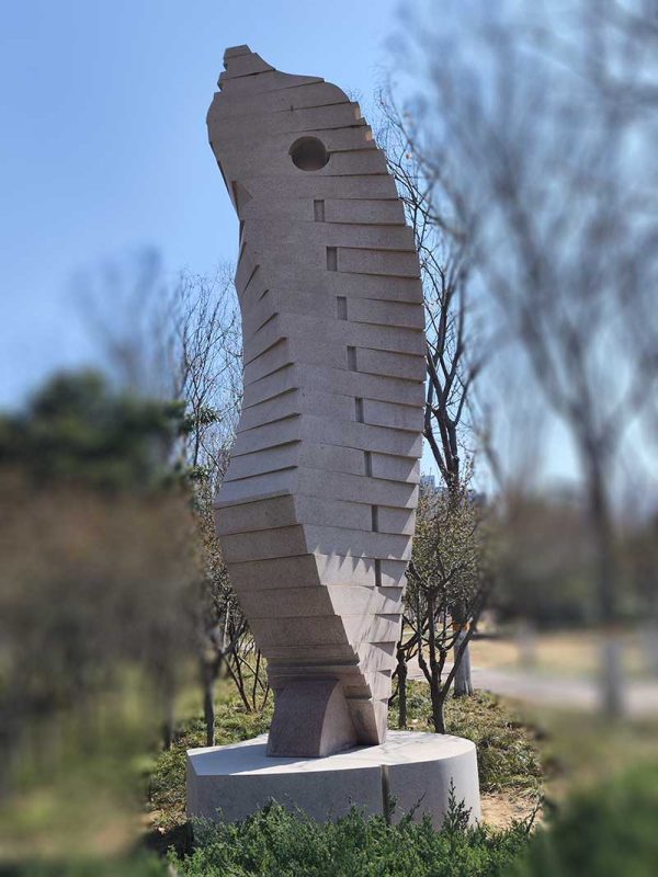 Stone Sculpture: An Abstract Standing Figure Observing and Alert in Twisting