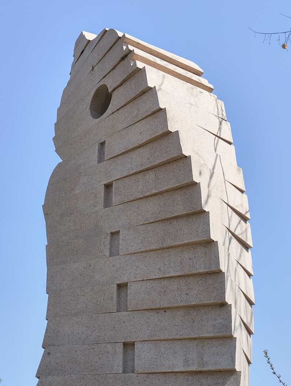 Stone Sculpture: An Abstract Standing Figure Observing and Alert in Twisting