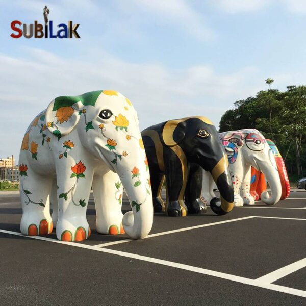 A fiberglass reinforced plastic painted elephant sculpture in an outdoor park - Image 2