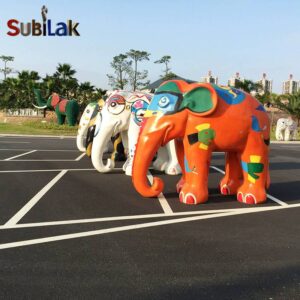 A fiberglass reinforced plastic painted elephant sculpture in an outdoor park