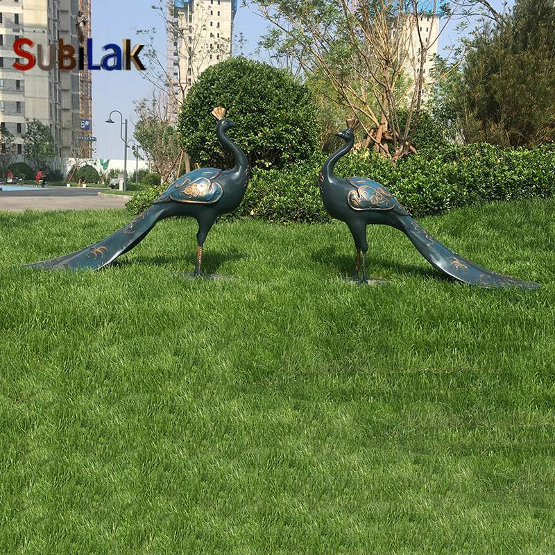 outdoor fiberglass peacock sculpture in the park